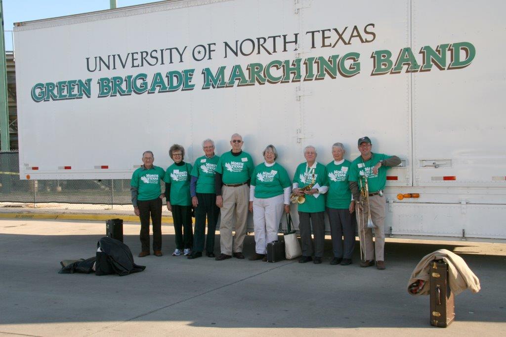 UNT Green Brigade Alumni standing inline in front of Green Brigade Trailer